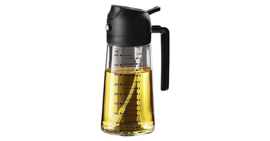 Glass oil dispenser bottle with measurement markings and black handle lid for precise pouring