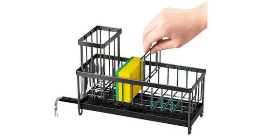 Black sink caddy organizer with compartments for sponge, brush, and soap, featuring a drainage tray and rustproof design